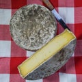 French tomme cheese for sale on a market stall Royalty Free Stock Photo