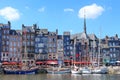 French town street with beautiful colorful houses and yachts in the bay on foreground. Summer town landscape with sunny