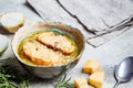 French traditional onion soup with baguette and cheese in gray ceramic bowl