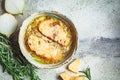 French traditional onion soup with baguette and cheese in gray ceramic bowl, top view