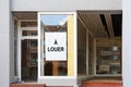 French vacancy sign in empty shop window reads a louer meaning for rent