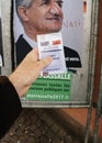 French voter registration card held in front of Jean Lassalle po
