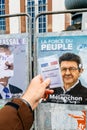French voter registration card held in front of Jean-Luc Melench