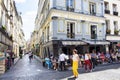 French woman passes by a cafe/bistro