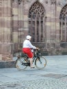 French woman in red skirt on bicycle