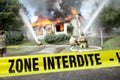 French Zone Interdite tape with firefighters and a burning house Royalty Free Stock Photo
