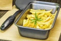 Frensh fries with rosemary on the table in dish