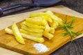 Frensh fries with rosemary on table