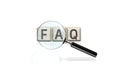 Frequently asked question concept, faw writing on cubes and magnifier Royalty Free Stock Photo