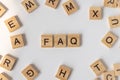 Frequently asked questions Concept. Wooden letter block wording FAQ with other letters on white background Royalty Free Stock Photo