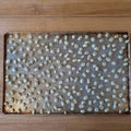 Fresch gold Christmas eve biscuits Kuciukai made from yeast dough with poppy seeds on baking tray in a bakery, food and