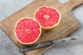 Sliced grapefruit on cutting board with knife Royalty Free Stock Photo