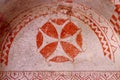 Frescos in ancient cave church painted in red directly onto rock