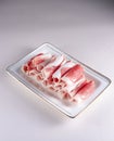 fresh and aesthethic bacon rolls on a white plate. View from above. Chinese cuisine, ingredient for hotpot