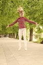 Fresh air gives her the vital energy. High energy or hyperactive kid. Small girl jumping in casual fit for energetic Royalty Free Stock Photo