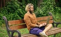 Fresh air. Mobile internet. You can work anywhere. Online shopping. Agile business. Bearded guy sit on bench in park Royalty Free Stock Photo