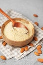 Fresh almond flour in a bowl and almonds