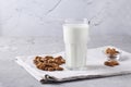Fresh almond milk in transparent glass and almonds on gray concrete background, Healthy vegan milk replacer, Horizontal format Royalty Free Stock Photo