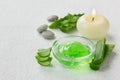 Fresh aloe vera leaf and aloe gel with burning candles on white surface Royalty Free Stock Photo
