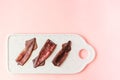 Fresh ancooked squids on white plate on pink background. Top view. Space for text Royalty Free Stock Photo