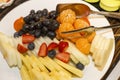 Fresh appetizing fruits and berries on a plate on the buffet table. Holidays, celebrations and business meetings. Close-up Royalty Free Stock Photo