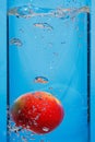 Fresh apple drops in water with splash