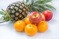 Fresh Apple Orange Pineapple on white table Royalty Free Stock Photo