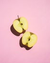 Fresh apple on a pink background. Sliced apple on a colored background. Royalty Free Stock Photo