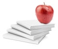 Fresh apple on stack of white books Royalty Free Stock Photo