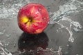 Fresh an apple in streaming water.