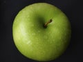 Fresh apple with water drops black background