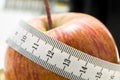 Fresh apple wrapped in a tape measure