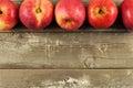 Fresh apples border on rustic aged wood