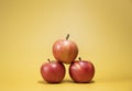 Fresh apples on a bright yellow background in an advertising foodphoto style