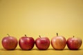 Fresh apples on a bright yellow background in an advertising foodphoto style