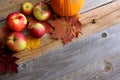 Fresh Apples, Pumpkins, and Maple Leaves Border Wood Background Royalty Free Stock Photo