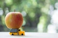 Fresh apples on toy truck. Concept of select of best fruit for export