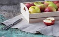 Fresh apples in a tray on a wooden background. Apples are red, green, yellow. Healthy Eating Vitamins Vegetarian Royalty Free Stock Photo