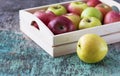 Fresh apples in a tray on a wooden background. Apples are red, green, yellow. Healthy Eating Vitamins Vegetarian Royalty Free Stock Photo