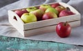 Fresh apples in a tray on a wooden background. Apples are red, green, yellow. Healthy Eating Vitamins Vegetarian Royalty Free Stock Photo