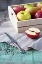 Fresh apples in a tray on a wooden background. Apples are red, green, yellow. Healthy Eating Vitamins Vegetarian Royalty Free Stock Photo