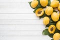 Fresh apricot berries with leaves on a light table.