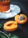 Fresh apricot cut in half with apricot jam on dark background Royalty Free Stock Photo