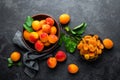 Fresh apricots with leaves and dried in bowl