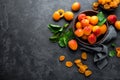 Fresh apricots with leaves and dried in bowl