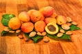 Fresh apricots, leaves and seeds on wooden surface Royalty Free Stock Photo