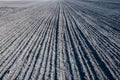 Fresh arable land in the form of vertical lines of black earth.