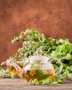 Fresh aromatic tea with melissa mint leaves glass teapot on a rustic background. Healing herbal drink. Vertical frame. Royalty Free Stock Photo