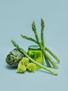 Fresh Artichoke, Asparagus and Romanesque cabbage on a grey background