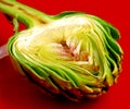 Fresh artichoke on the red plate